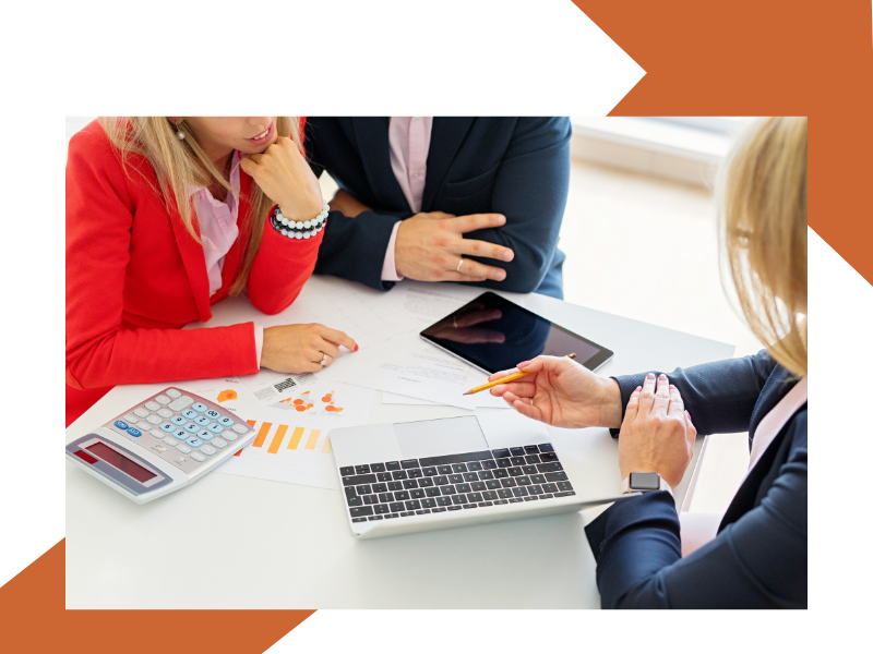 A couple looking at docmentaiton<br />
with their financial adviser 