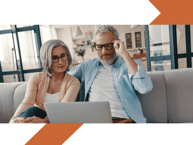 Retirement couple on the sofa looking at a laptop