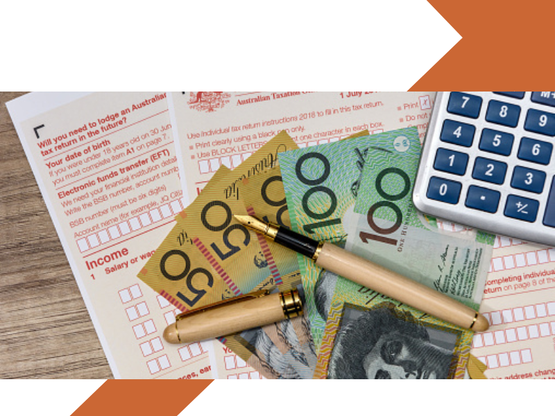 Tax forms with $50 and $100 dollar notes on top with a fountain pen and calculator.