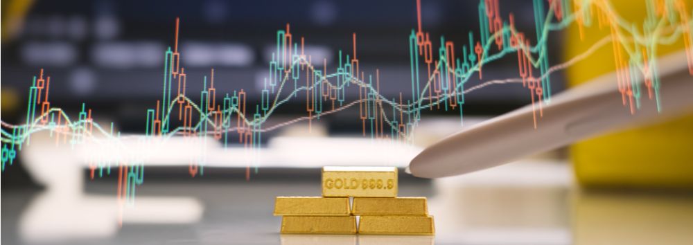 stock market background image showing the rise in the price of gold. Gold bar pile at the front of the screen