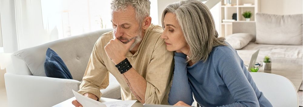 strategies for an unexpected retirement retiree couple looking at documents at a desk