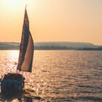 sailing boat out on the sea during twighlight