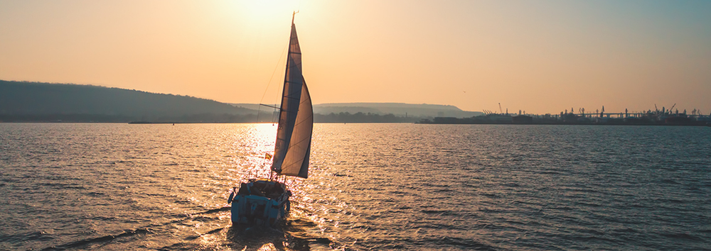 sailing boat out on the sea during twighlight
