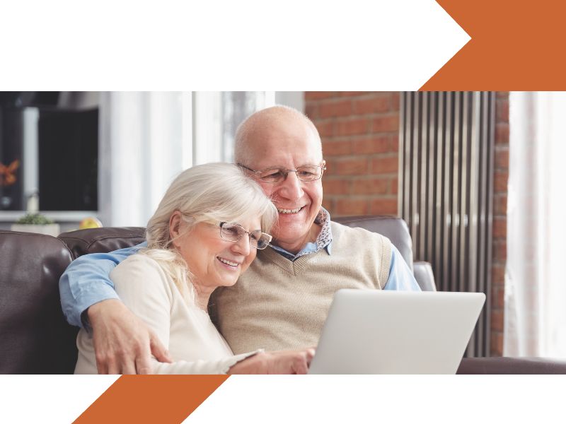 retired couple looking at a laptop